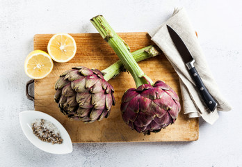 Fresh big Romanesco artichokes green-purple flower heads ready to cook seasonal food
