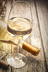 Glass of white wine on vintage wooden table