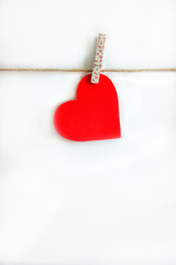 Red heart hanging on the clothesline