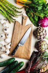  food background with Italian spring and summer vegetables and fruits. top shot with cutting board