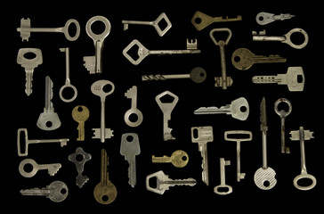 set of used old keys on black background