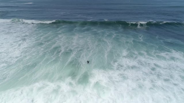 Aerial view of a surfer in the ocean