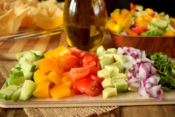 Chopped vegetables on a wooden board. Salad ingredients