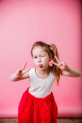 Little girl emotions on pink background