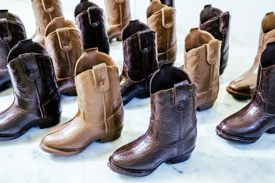 High angle view of shoes shaped chocolates on table at factory