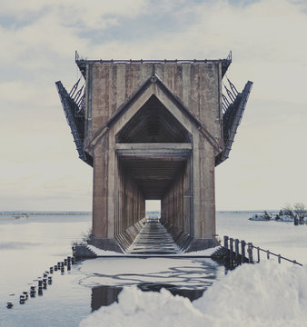 Ore dock by Lake Superior against sky during winter