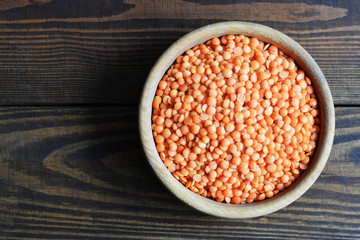  Top view of red lentils in wooden bowl