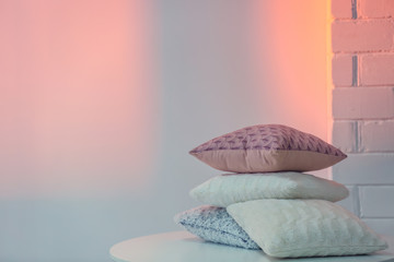 Different soft pillows on table