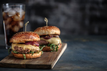 Homemade tasty hamburger with beef, cheese and caramelized onions. Street food, fast food. Copyspace © FoodAndPhoto