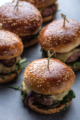 Homemade juicy burgers with beef, cheese and caramelized onions. Street food, fast food