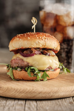 Homemade juicy cheeseburger with beef, cheese and caramelized onions. Street food, fast food