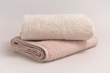 Soft bath towels on grey background