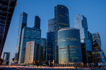 Fototapeta na wymiar Skyscrapers in Moscow in the evening, the frozen river