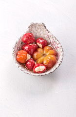 Bowl of small cheese stuffed peppers and tomato