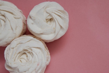 Obraz na płótnie Canvas White Homemade Marshmallows or Zephyr. White AppleDesert over Pink Background. Copy Space.
