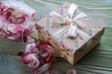 Gift in a box, glass with petals, top view