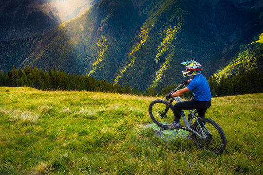 Mountain Biker Wearing Full Face Helmet Admiring Landscape