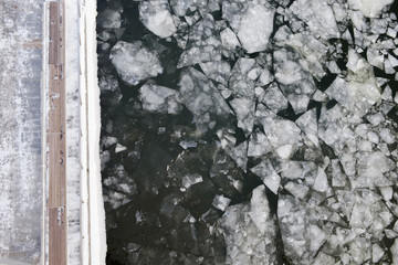 Pier and frozen river, ice, top view