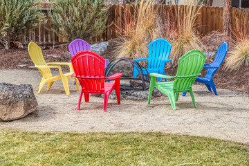 Colorful chairs around the fire pit