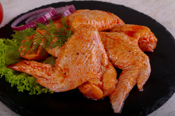 Raw marinated chicken wings