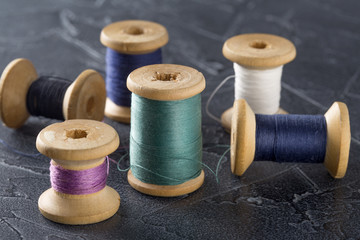 sewing thread in different colors pink blue green white