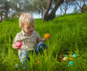 Obraz na płótnie Canvas Cute toddler picking eggs