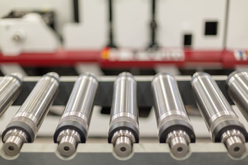 Lined up magnetic cylinders for die cut on rotary printing press. Magnetic cylinder for flexo...