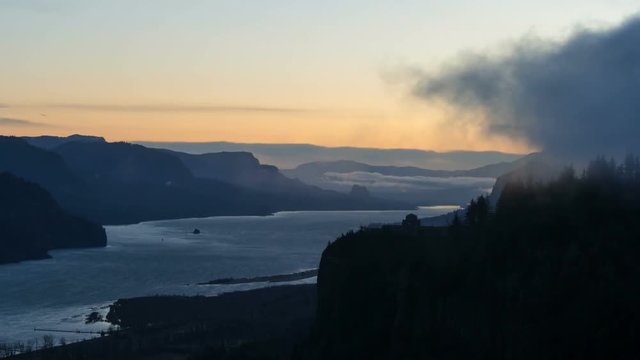 Time lapse movie of moving clouds and sky over beautiful Columbia River Gorge from Chanticleer Point with view of historic Vista House during sunrise one early morning in Oregon 4k UHD