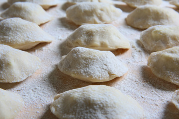 Dumplings homemade cheese and potatoes on a pastry board 