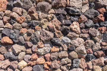 Background with lava stones of many colors in Santa Cruz on the island of Tenerife