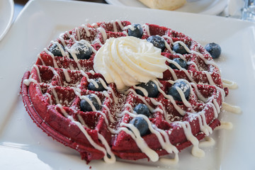 Close up shot of delicious pancake with blueberry and cream