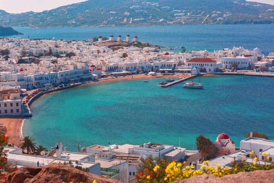 Fototapeta Aerial view of Mykonos City, Chora with Old Port, white houses, windmilles and churches on the island Mykonos, The island of the winds, Greece