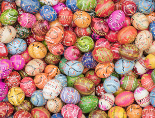 Basket full of traditional Polish, multi-colored, handpainted wooden Easter eggs 