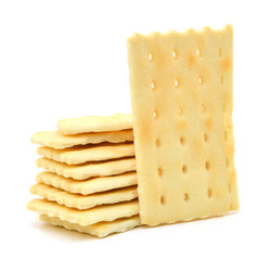 Stack of saltine crackers isolated on white.