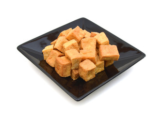 Fried Tofu in black plate on white