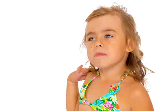 Tanned little girl in a swimsuit Stock Photo