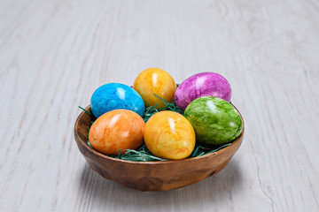 easter eggs in bowl on a wooden background