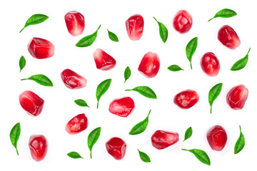 pomegranate seeds decorated with green leaves isolated on white background. Top view. Flat lay pattern
