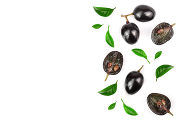 Dark grapes decorated with green leaves isolated on white background with copy space for your text, top view. Flat lay