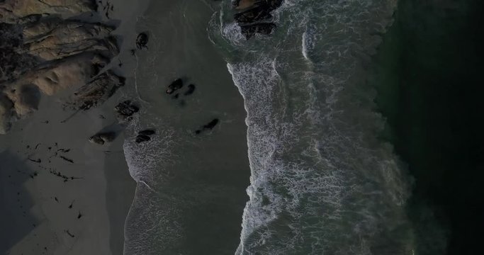 4K high quality aerial video footage of Western Cape's coast, Paternoster beach boulders, sandy sea front and Atlantic Ocean views in the background near Cape Town, South Africa on summer morning