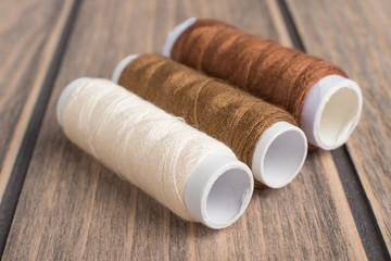 Threads on a wooden texture. Macro