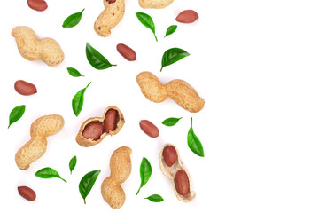 Peanuts with shells decorated with green leaves isolated on white background with copy space for your text, top view