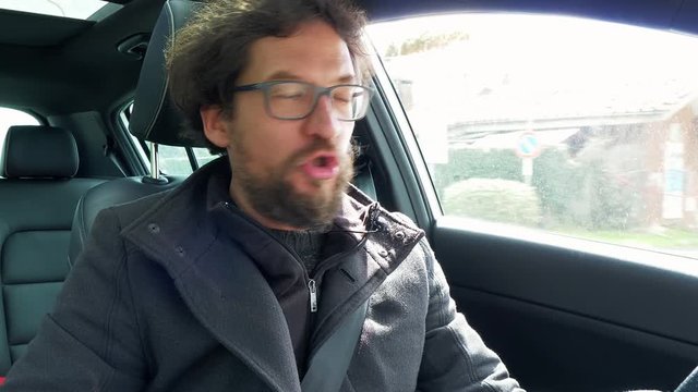 Man talking to camera video phone call driving car closeup