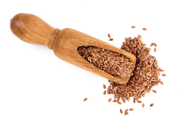 flax seeds in wooden scoop isolated on white background. Top view