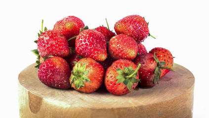 fresh strawberries on wood and white background