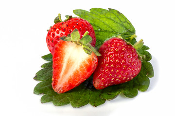strawberry with sliced half and leaves isolated on white background