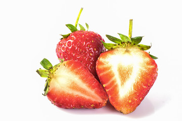 strawberry with sliced half and leaves isolated on white background