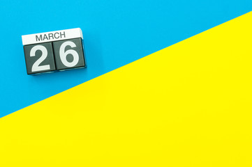 March 26th. Day 26 of march month, calendar on blue and yellow background flat lay, top view. Spring time. Empty space for text