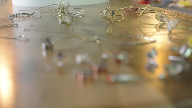 Hand made jewelry is on a table at a craft market