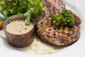 Top view close up of Grilled Pork chop serve with vegetable on white dish